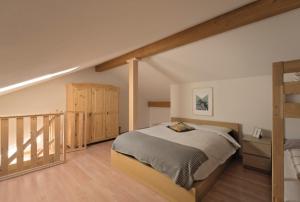 a bedroom with a bunk bed and a staircase at Holiday Home Julia in Valdaora