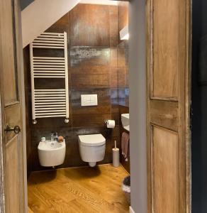 a bathroom with a white toilet and a sink at CivicoNove in Montefalco