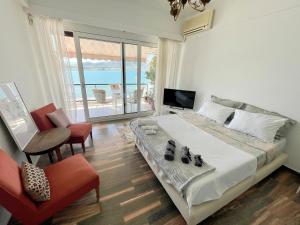 a bedroom with a bed with a view of the ocean at Marine Apartment with sea & port view! in Volos