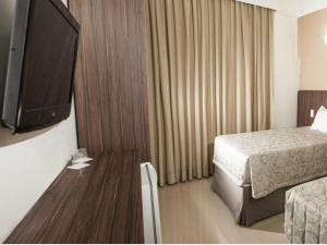 Llit o llits en una habitació de Hotel Abba Uno