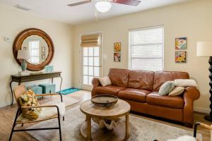 a living room with a brown leather couch and a mirror at Relax at Renellie in Tampa