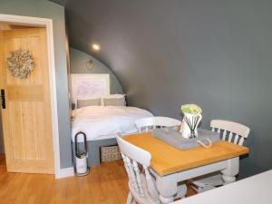 a small room with a table and a bed at Oak in Uttoxeter