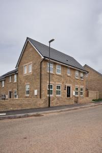 a brick building with a street light in front of it at Peak District New Modern Cottage with Mountain Views in Buxton