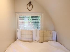 a bed in a room with a window at Elm in Uttoxeter