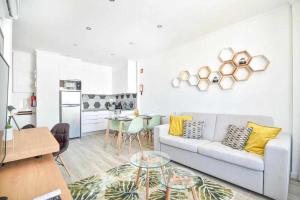 a white living room with a couch and a table at Timeless Beach III Apartment in Armação de Pêra +26 photos