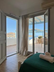 a bedroom with a bed and a view of the ocean at Katerina Apartments & Studios in Naousa