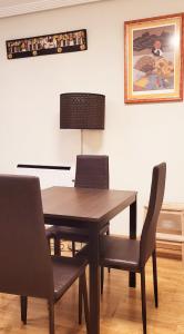 a dining room with a table and two chairs at www Goyahospitales es Peñalba Parking incluido in León +23 photos