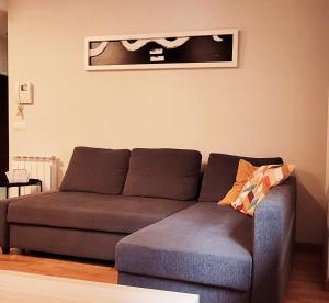 a living room with a couch and a picture on the wall at www Goyahospitales es Peñalba Parking incluido in León