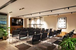 a room with rows of chairs in a building at Teight Hotel in Thessaloniki