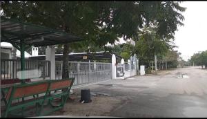a bus stop with a bench next to a fence at ZR D'Chili Homestay, Kemaman in Cukai