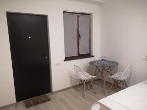 a room with a black door and a table and chairs at 7ROOMS boutique hotel in Yeghegnadzor