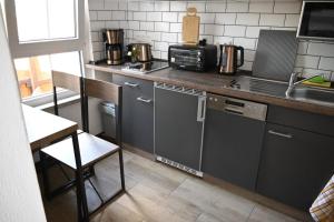a kitchen with a counter with a sink and a microwave at Studio Edeltraud zentral in Wernigerode