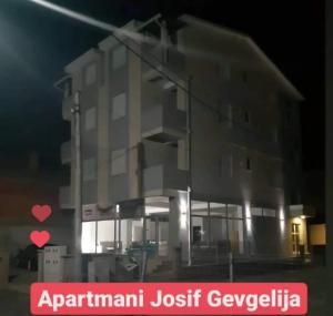 a building at night with a sign in front of it at Apartments Josif in Gevgelija