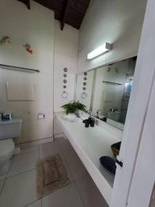 a bathroom with a sink and a toilet and a mirror at 6 Sandy Surf, Worthing Christ Church in Christ Church