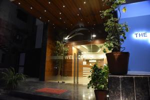 a lobby of a building with a door with plants at The Pacific Hotel in Vadodara