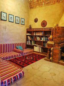 a living room with a couch and a fireplace at Scorpion House Luxor in Luxor