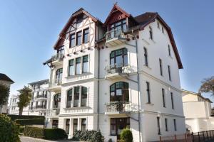 - un bâtiment blanc avec des fenêtres et des balcons dans l'établissement Villa Medici 10 a, à Ahlbeck