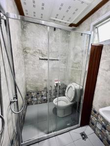 a bathroom with a shower with a toilet and a sink at Suan Nai Kokut Resort in Ko Kood