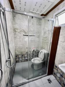 a bathroom with a shower with a toilet and a sink at Suan Nai Kokut Resort in Ko Kood +68 photos
