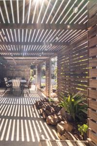 a patio with a wooden pergola at The Boathouse - Freycinet Holiday Houses in Coles Bay