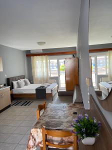 a living room with a bed and a dining table at Artemis Hotel Apartments in Keramoti