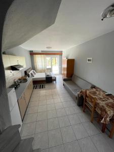 a kitchen and living room with a couch and a table at Artemis Hotel Apartments in Keramoti +28 photos