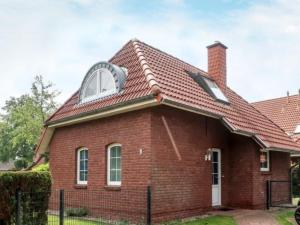 a house with a pitched roof with a window at Ferienhaus Fröhlich in Norden