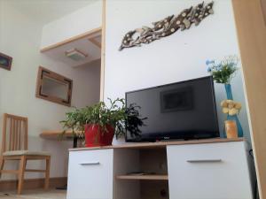 a living room with a tv on a white entertainment center at Woody in Valjevo
