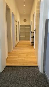 a hallway with wooden floors and shelves in a room at Apartment am Zollverein -WiFi - Parking for free in Essen