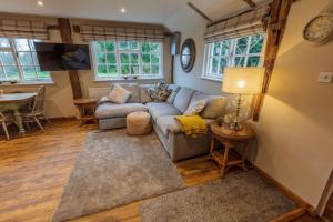 a living room with a couch and a table at Halfmoon Lodge @ Knights Hole wheelchair access in Cranbrook