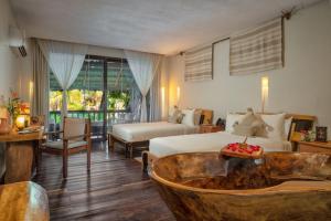 a hotel room with two beds and a tub at Kanan Tulum - Adults Only in Tulum