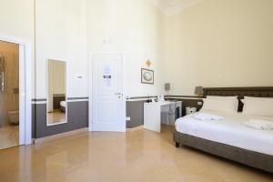 a bedroom with a bed and a bathroom with a sink at Residenza Molinari Suite in Naples +72 photos