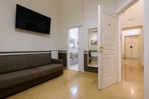 a living room with a couch and a flat screen tv at Residenza Molinari Suite in Naples