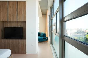 a bedroom with a large window and a tv at Matteotti28 in Pesaro