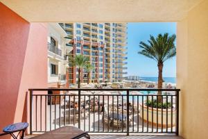 a balcony with a view of a hotel and the ocean at Emerald Grande W222- Rexford's BEACH Retreat in Destin