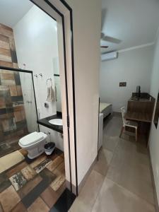 a bathroom with a toilet and a sink at Hotel Ibirapuera in Barretos +80 photos