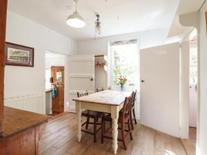 a kitchen and dining room with a table and chairs at Warren Cottage in Leavenheath