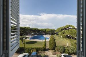 a view of a pool from a building at LETS HOLIDAYS Beach front apartment in Gavà Mar, Pine Beach in Gavà