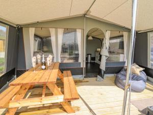 a tent with a wooden table inside of it at The Heron in Rhayader