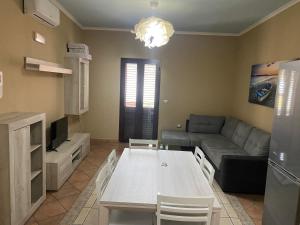 a living room with a couch and a table at Appartamento Orrosica in Tertenìa
