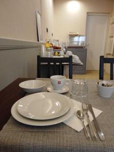 a table with a white plate and silverware on it at Hotel Camilla Firenze in Florence