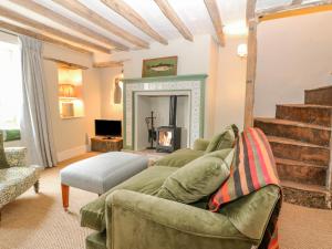 a living room with a couch and a fireplace at 31 Manor Road in Charlbury