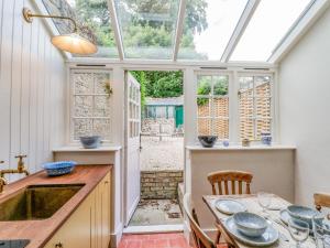 a kitchen with a table and a sink and a window at 31 Manor Road in Charlbury