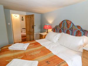 a bedroom with a large bed with a wooden headboard at 31 Manor Road in Charlbury