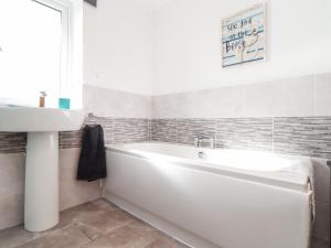 a bathroom with a white tub and a sink at Atlantic Reach in Marazion +27 photos