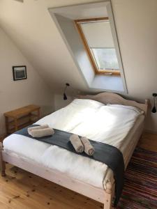 a bedroom with a bed with two towels on it at Istrup gammel skole in Bedsted Thy