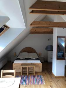 a bedroom with a bed with a wooden bed frame at Istrup gammel skole in Bedsted Thy
