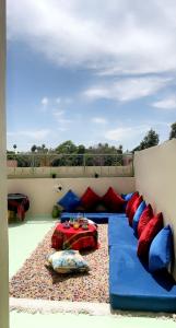 a living room with a couch and a table on a balcony at Peace Hotel in Marrakesh