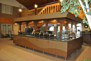 a large kitchen with a counter in a building at C'Mon Inn in Thief River Falls