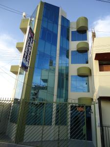 a building with a sign on the side of it at Hostal Puerto Ingles in Ilo